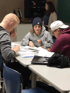 Students in a 12th grade English class at Binghamton High School work with SUNY Broome students on a forensic psychology class project