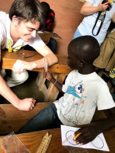 Kevin Carr teaching a child in Haiti