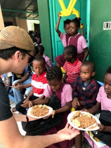 Serving food to Haitian children