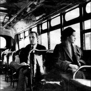 Rosa Parks sits in the front of a bus in Montgomery, Alabama, in 1956 after the U.S. Supreme Court ruled segregation illegal on the city's bus system. Behind Parks is Nicholas C. Chriss, a UPI reporter covering the event.  United Press photo.