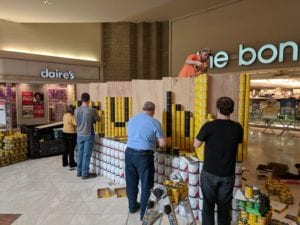 Students and faculty construction SUNY Broome's Canstruction entry on April 8.