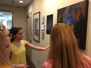 Ashlynn Kelley, LAAS 2016, discusses her artwork at the opening reception for the Alumni Art Show.