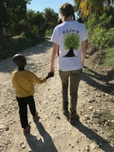 Phoebe Macauley makes a friend in Haiti.