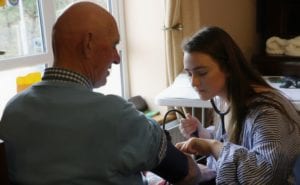 A SUNY Broome student conducts a health screening in Ireland.