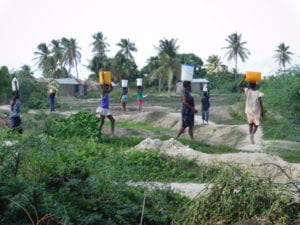 Residents of Grande Saline carrying water