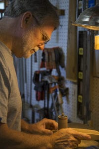 SUNY Broome alumnus Rich Nolan works on a sculpture in his workshop.