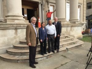Left to right: SUNY Broome President Kevin E. Drumm, Assemblywoman Donna Lupardo, Assembly Speaker Carl Heastie and Broome County Executive Jason Garnar on the steps of the former Carnegie Library.