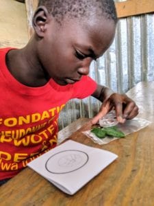 A Haitian child working on an art project