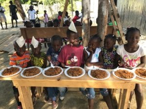 Haitian students eat a meal 