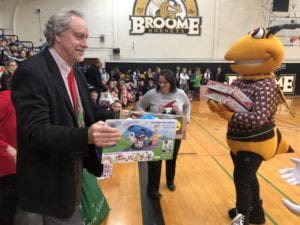 President Drumm makes his donation during the 2018 Giving of the Toys