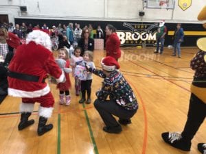 Children from BC Center donate new toys to Santa during the 2018 Giving of the Toys