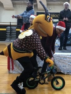 Stinger rides a bike donated by the CLT Club
