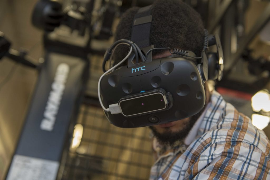 A worker using Raymond Corporation's virtual reality forklift simulator