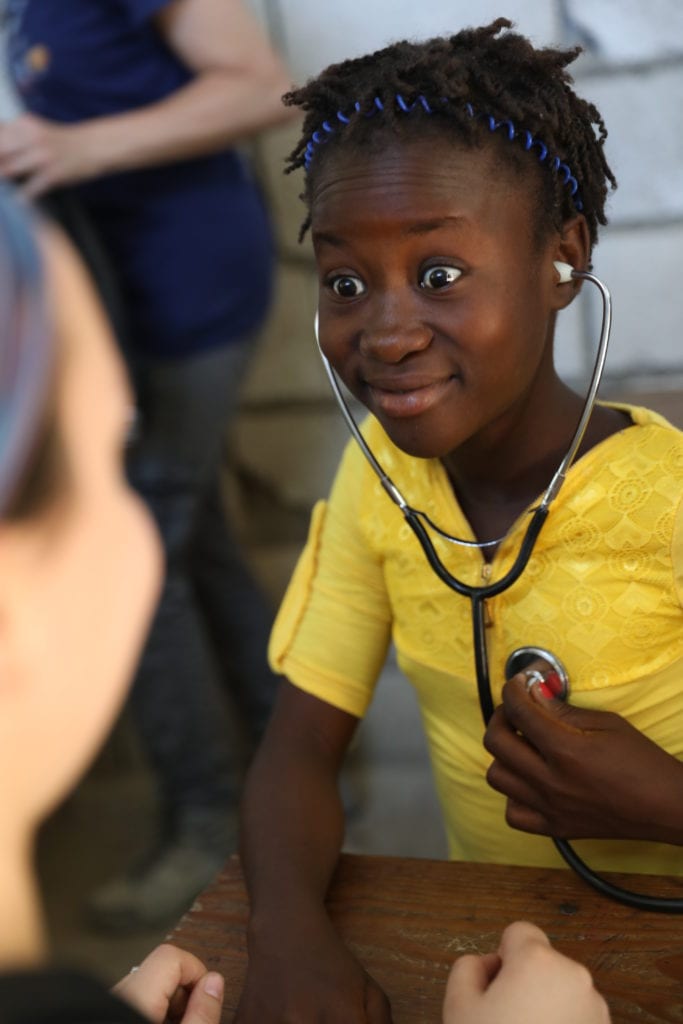 After learning about how the heart works from Health for Haiti students, Elena listened to her heart beat for the first time