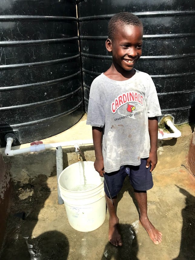 A child in Grande Saline, Haiti, with fresh drinking water