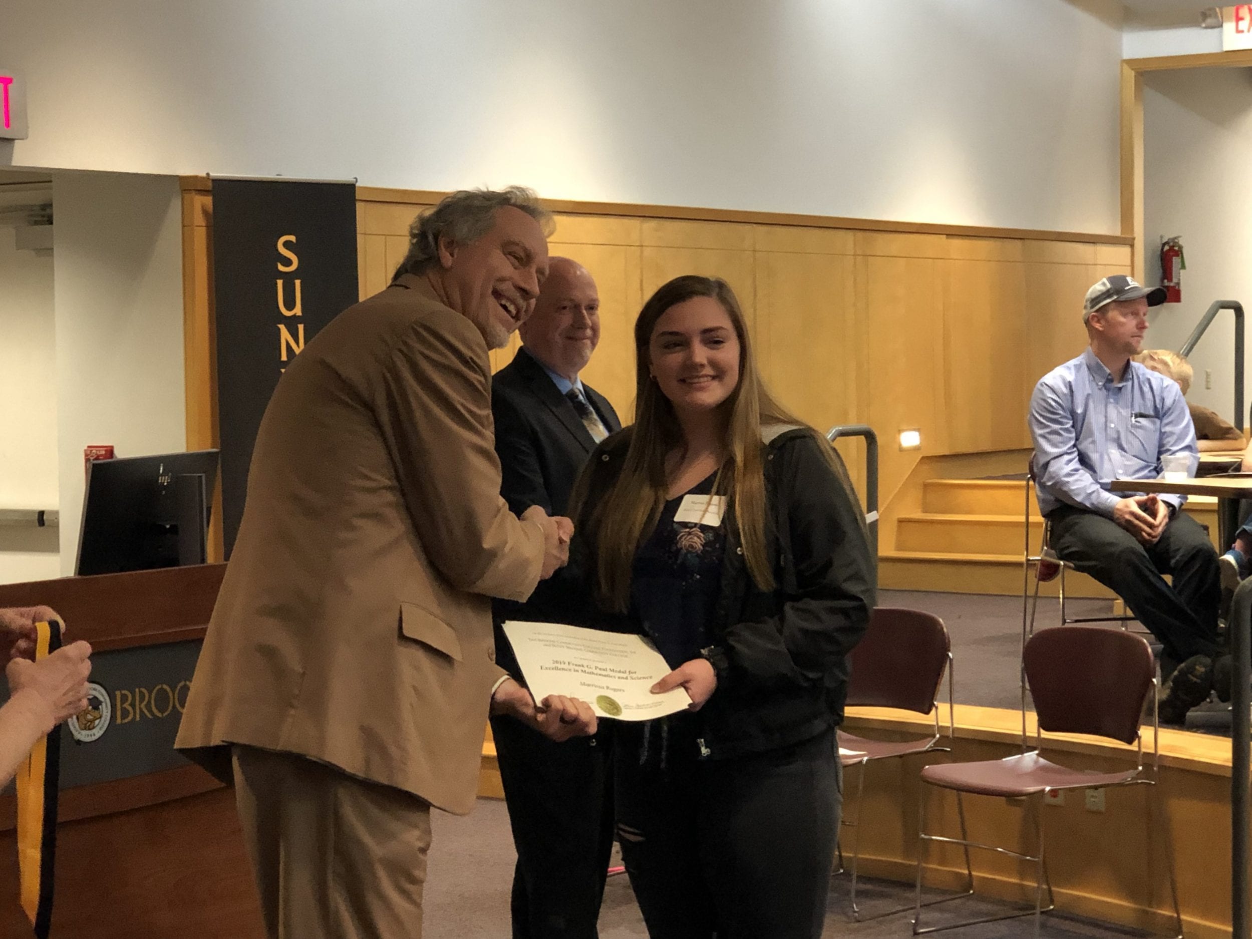 Marrissa Rogers receives the Frank G. Paul award from SUNY Broome President Kevin E. Drumm