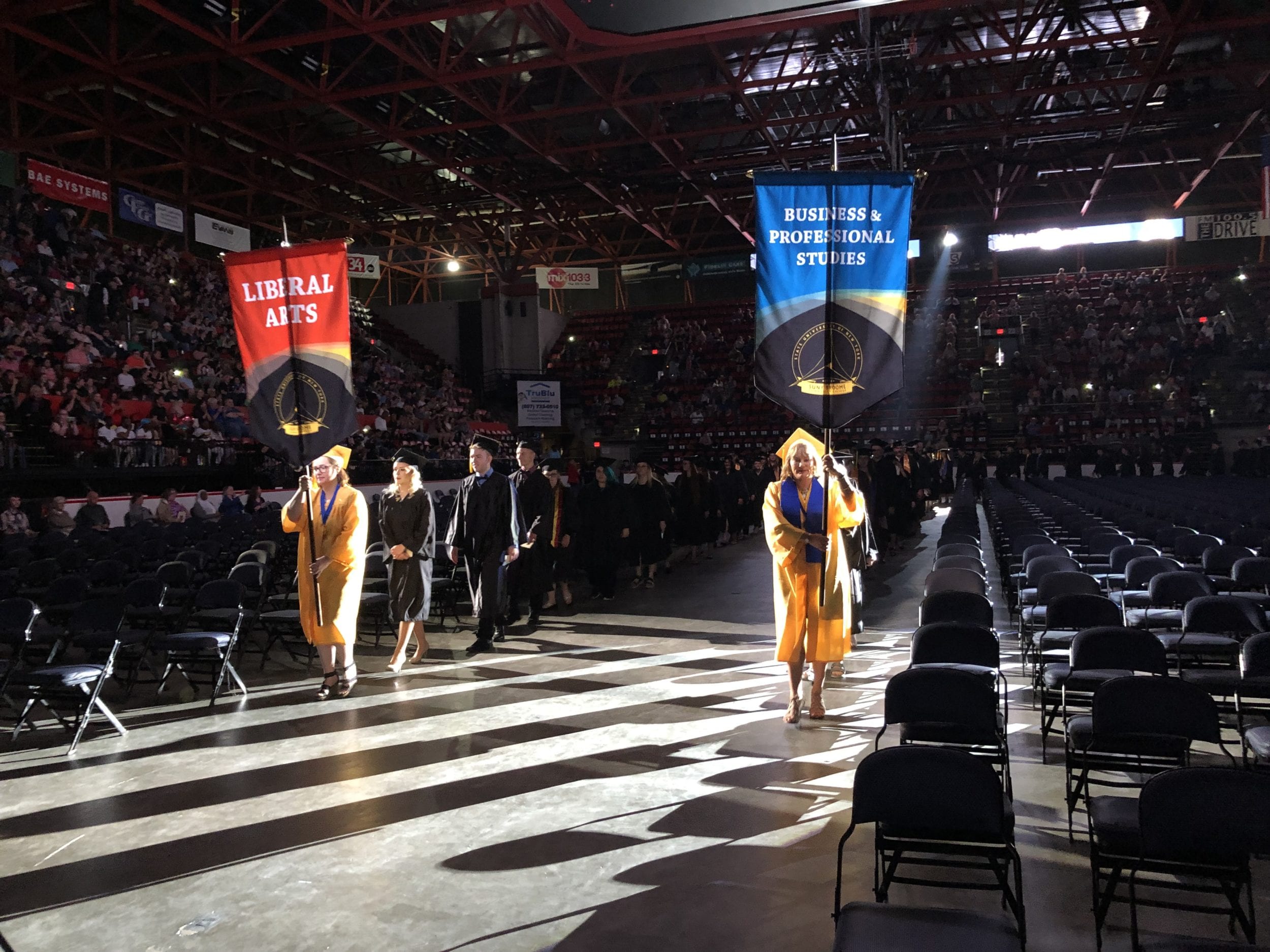 Students process into Commencement 2019, led by students Nakeesta Langton for Liberal Arts and Rachael Klug for BPS.