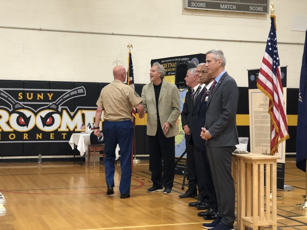 SUNY Broome President Kevin Drumm greets a Vietnam War veteran.
