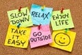 Post-it notes that say "slow down," "relax," "enjoy life," take it easy," "Go outside," and a smiley face