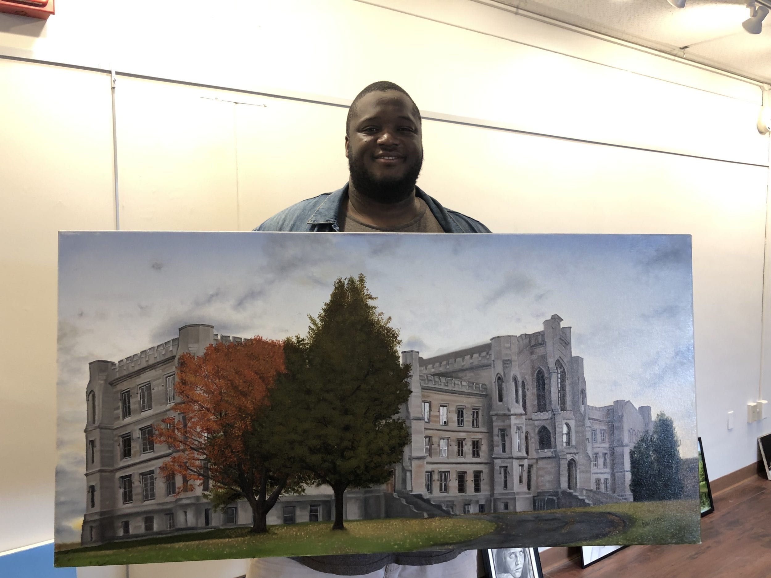 Bernard Morille with the oil painting of Binghamton's historic Inebriate Asylum, now on display in the library art gallery.