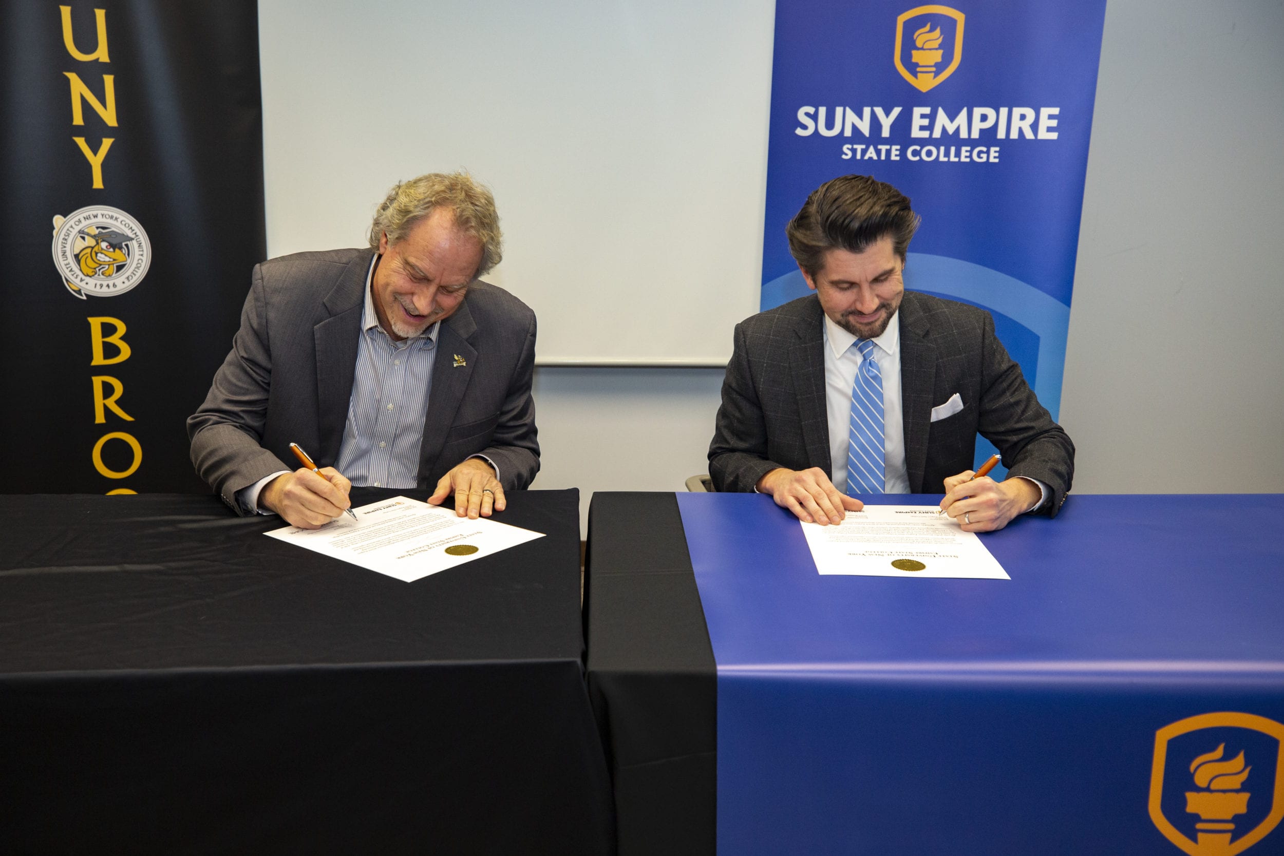 SUNY Empire State College President Jim Malatras and SUNY Broome President Kevin Drumm (left) sign a transfer agreement between the two schools