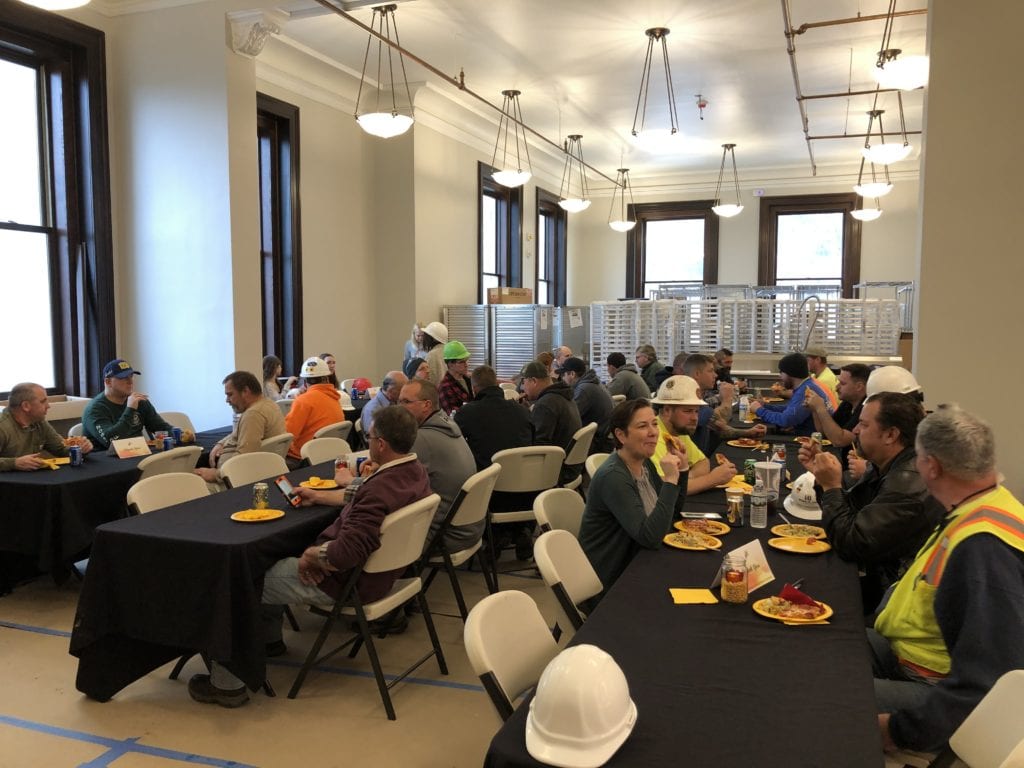 Workers at the CEC enjoy a pizza luncheon