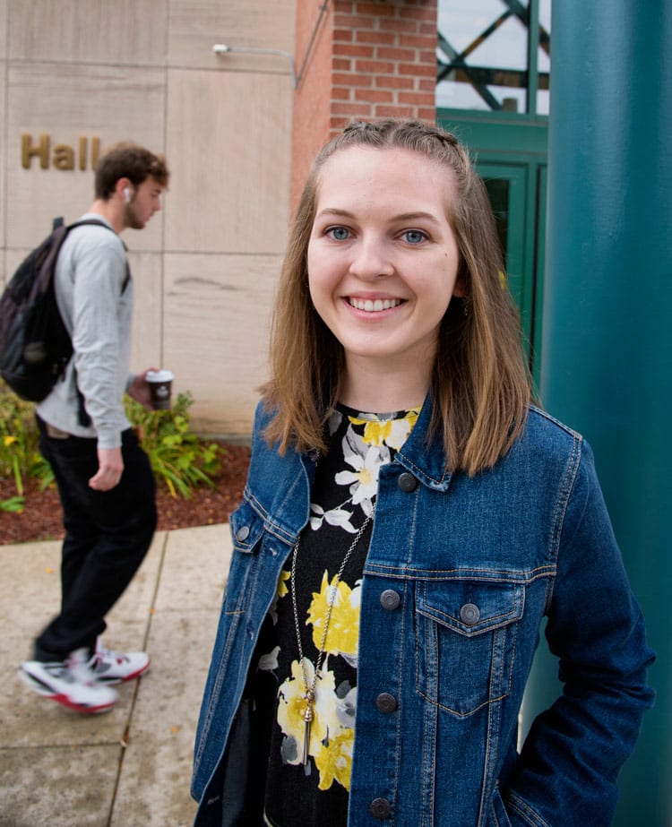 Natalie smiles as she stands outside Titchener Hall.