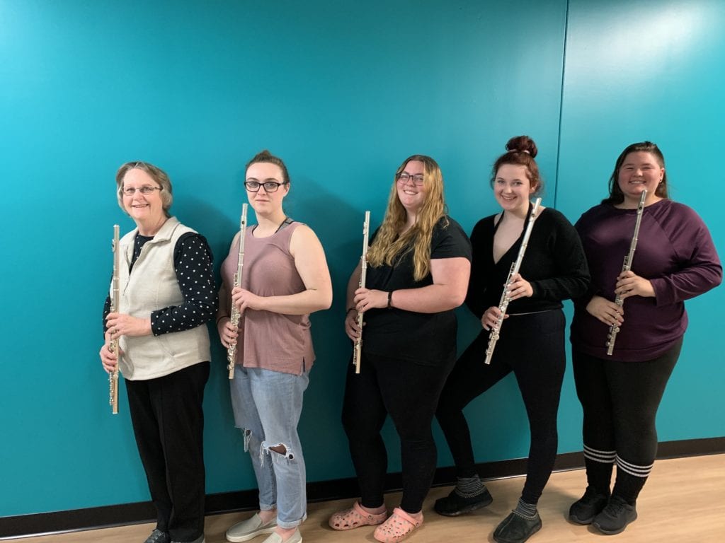 Vivian Gates, Freya Randall, Emily Woughter, Kristine Farley and Evelyn Vincent, all holding flutes