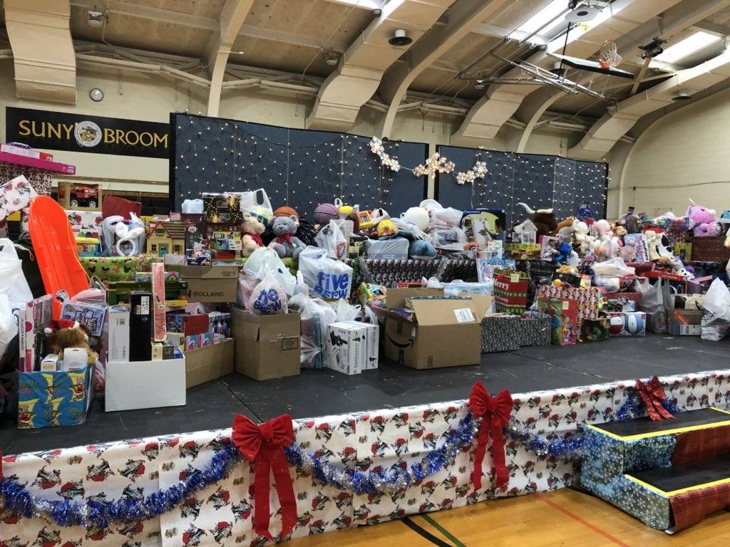The stage in the Baldwin Gym is loaded with donations to Toys for Tots after the December 2019 Giving of the Toys.