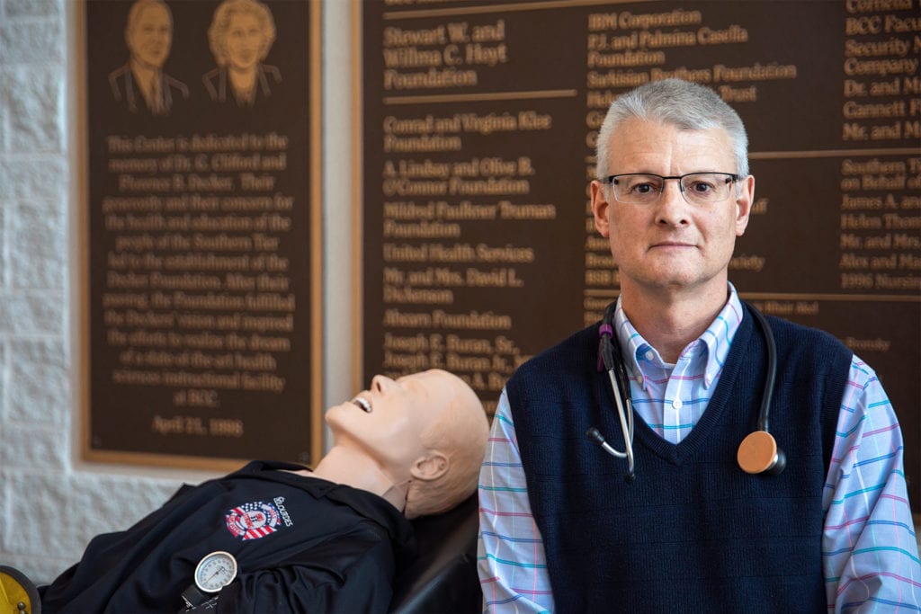 SUNY Broome alumnus and instructor Bob Parke with one of the Paramedic/EMT program's manikins 