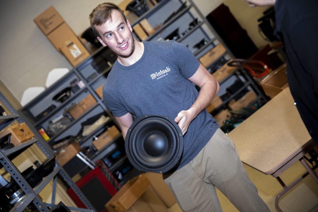 McIntosh CEO Charles Randall's son, Charles, holds a speaker component in the company's R&D facility