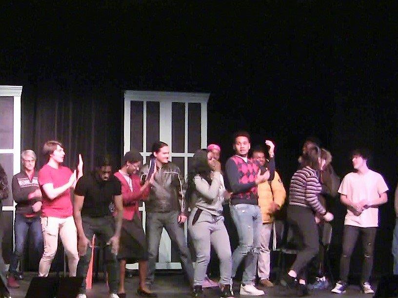 group of students dancing on stage 