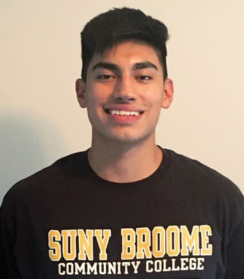 Daniel is wearing a smile and a SUNY Broome T-Shirt.