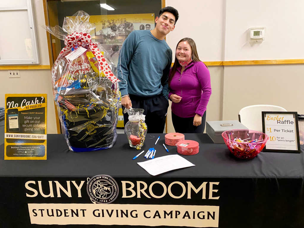 SUNY Broome Student Giving Campaign; table with 2 students and a gift basket raffle