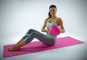 Yoga instructor on a pink yoga mat