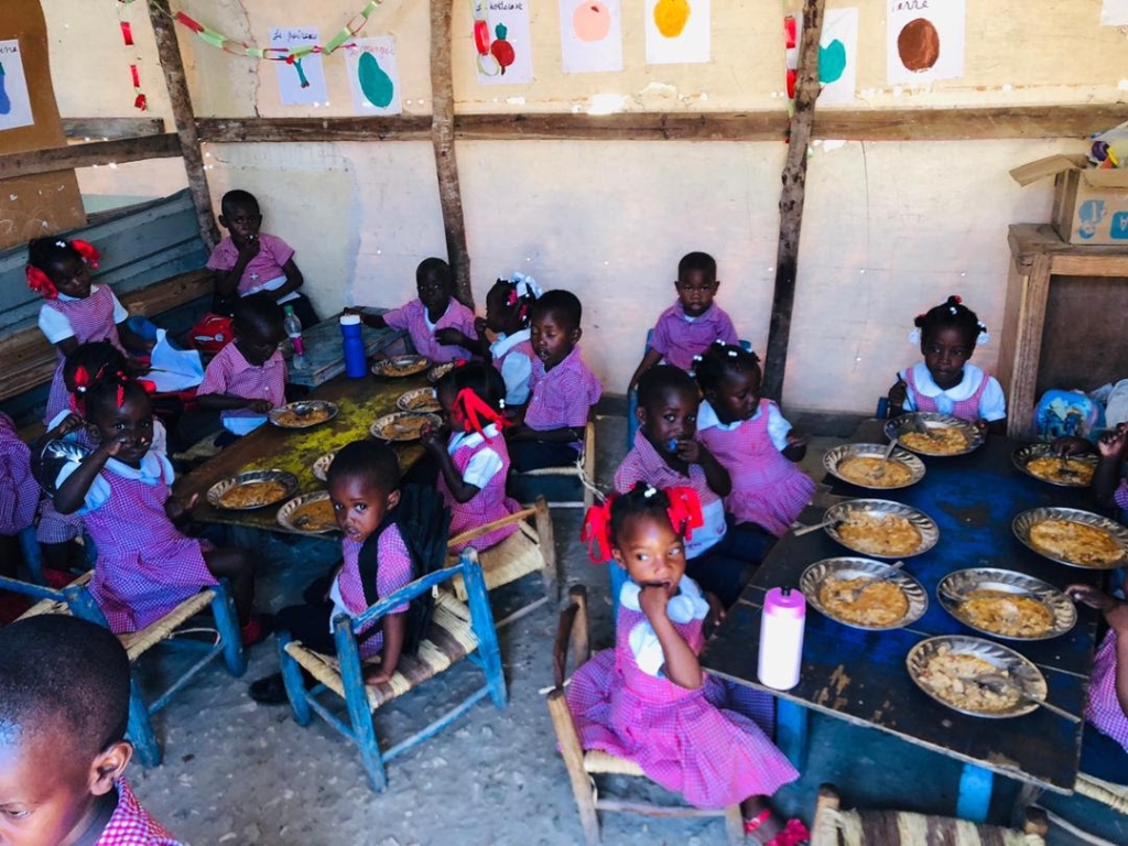 Health for Haiti New Kitchen completed. Haitian children enjoying food prepared in the new kitchen.