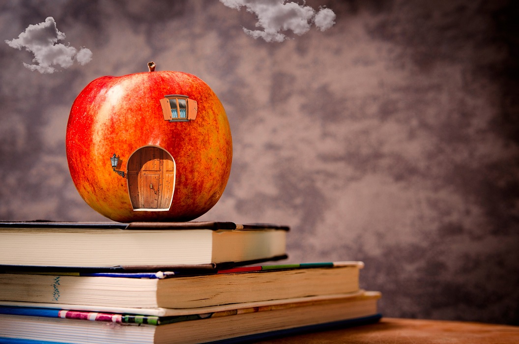 Teaching logo featuring a pile of books and an apple
