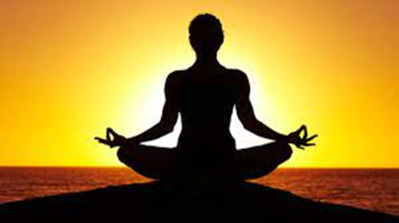rising sun with silhouette of person in a meditation pose