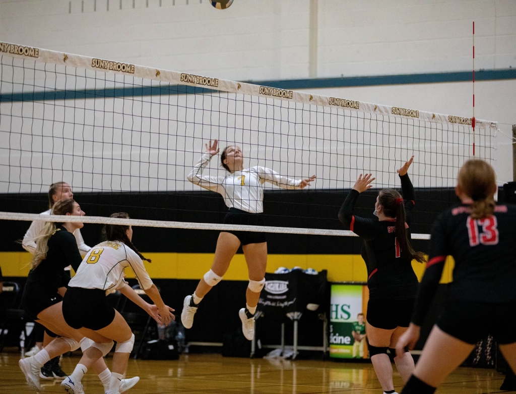 Megan Carden jumping to hit the volley ball