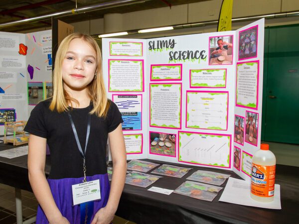 Arabella Laine, an elementary student at Chenango Forks, stand with her project titled "Slimy Science."