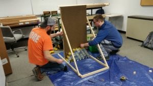 Tom Yarrington and Kyle McKane, Engineering Design II students, constructing a prototype of the "Stinger" facade that will be part of the SUNY Broome Canstruction entry at the Oakdake Mall during April 8-15.