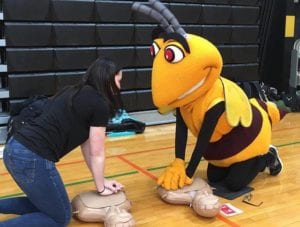 Medical Assisting students teach Stinger how to do hands-only CPR