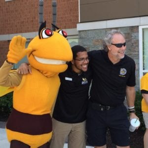 Stinger strikes a pose with SUNY Broome President Kevin Drumm and residence life staff on Move-In Day at the Student Village