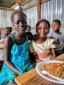 Children in Haiti with a plate of food