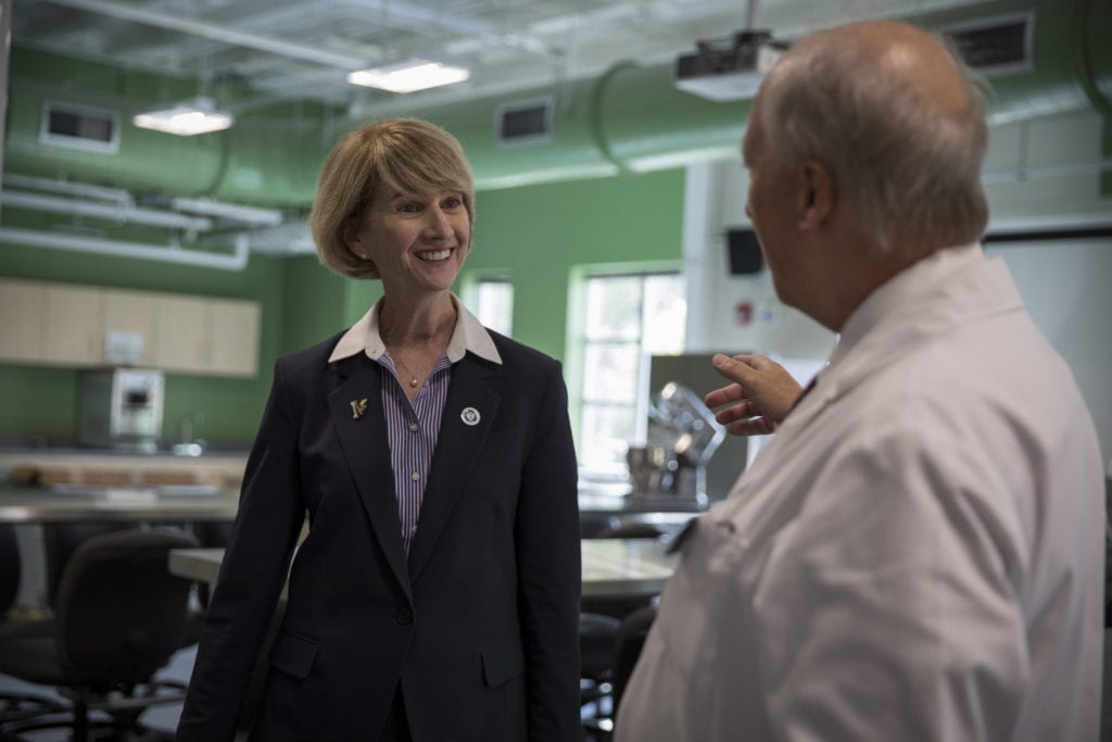SUNY Chancellor Kristina Johnson talks with Professor Howard Trimm in the food science laboratories.