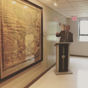 SUNY Broome President Kevin E. Drumm discusses a historic 1857 map donated by Professor Doug Garnar