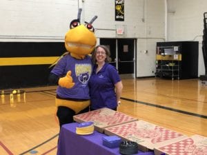Stinger meets with Bellevue staff during a celebration in the Baldwin Gym