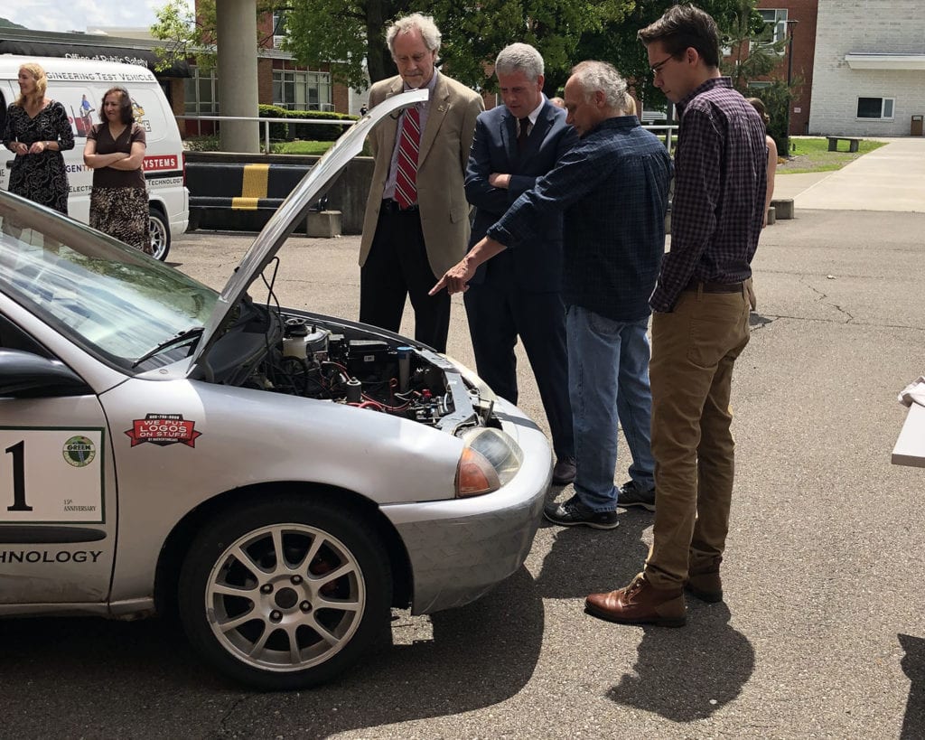 Left to right: SUNY Broome President Kevin Drumm, Broome County Executive Jason Garnar, Professor Gary DiGiacomo and student Mike DiGiacomo with the Chevy Metro that competed in the Green Grand Prix.