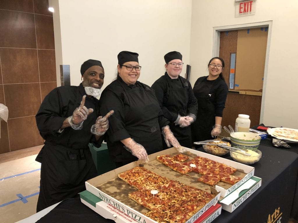 Hospitality students serve up pizza to the workers at the CEC