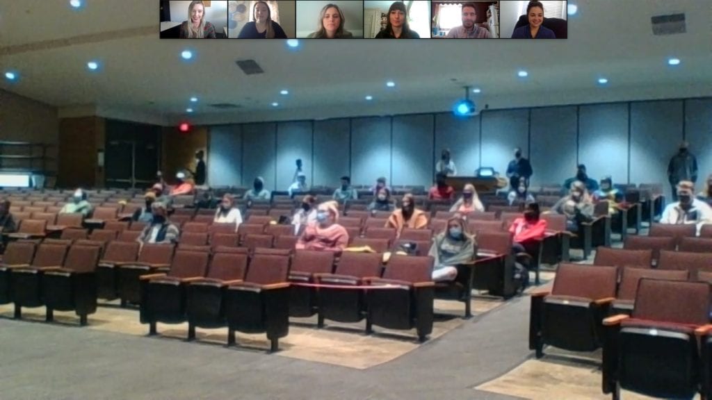 A screenshot image of The College Day Express event at Windsor high school, showing admissions staff giving a presentation to students.